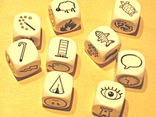 Story cubes showing magic wand, cane, sheep, tower, teepee, fish, turtle, word balloon, and eye