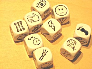 Story cubes showing abacus, eye, hand, sleeping face, flashlight, sad face, lightning bolt, footprint, and parachute