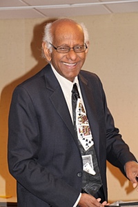 Thiagi standing and smiling